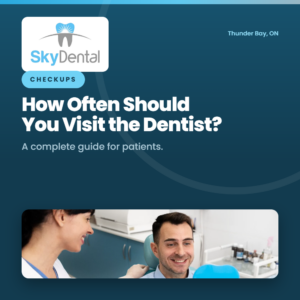 Female dental hygienist smiling at a male patient seated in the treatment chair, SkyDental Checkups blog cover: How Often Should You Visit the Dentist? – a complete guide for patients."