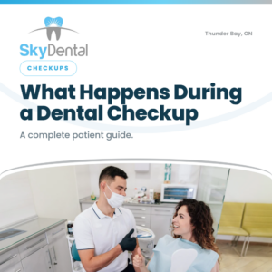 Masked male dentist giving a thumbs up to a smiling female patient in the chair, SkyDental Checkups blog cover: What Happens During a Dental Checkup – a complete patient guide.